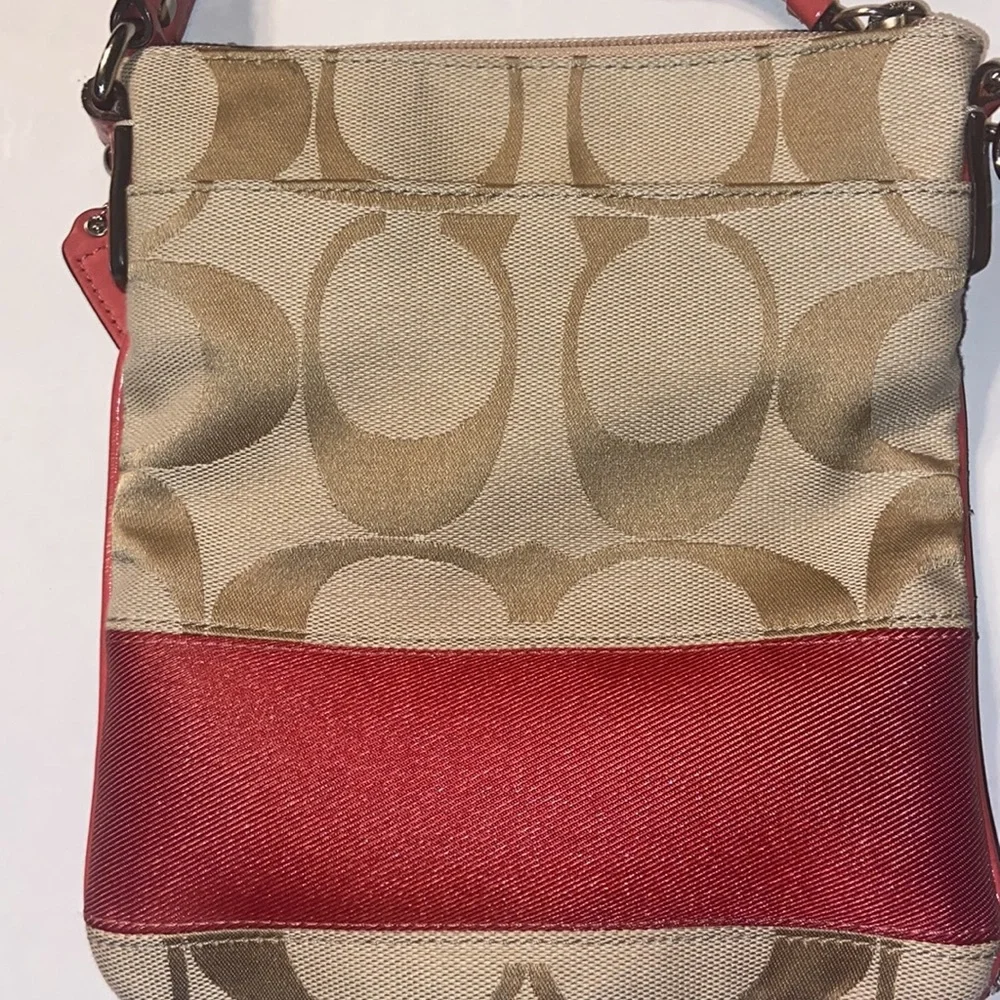 Tan and burnt orange Coach crossbody bag.